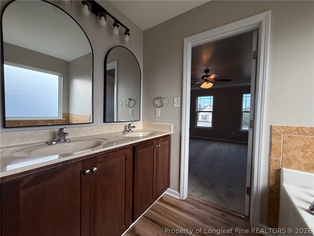 Undisclosed Address Spring Lake, NC 28390 - Photo 29 of 50 a bathroom with a double vanity sink and a mirror