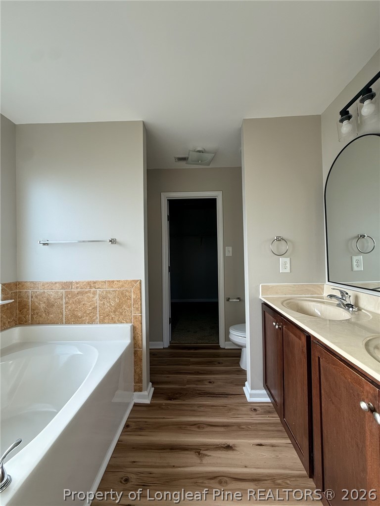 Undisclosed Address Spring Lake, NC 28390 - Photo 30 of 50 a bathroom with a tub sink and mirror