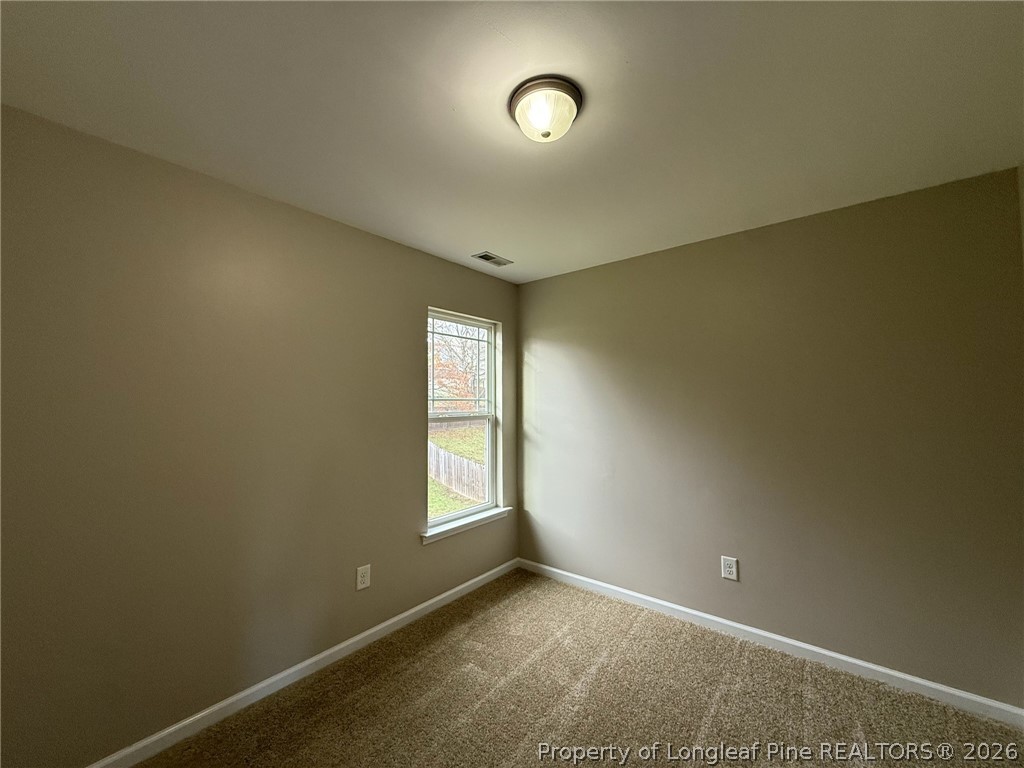 Undisclosed Address Spring Lake, NC 28390 - Photo 39 of 50 an empty room with windows and mirror