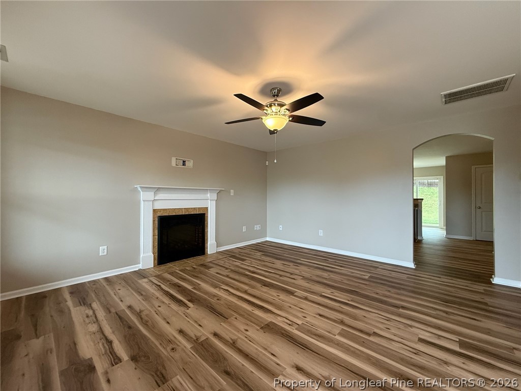 Undisclosed Address Spring Lake, NC 28390 - Photo 5 of 50 a view of an empty room with a fireplace and a ceiling fan