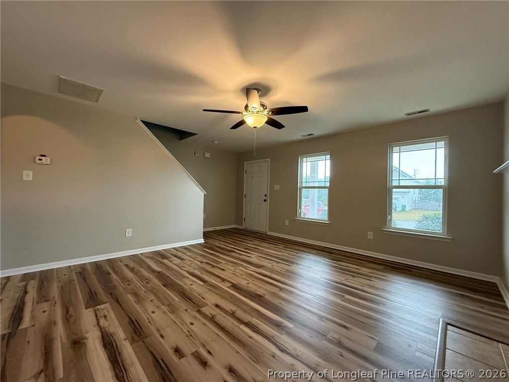 Undisclosed Address Spring Lake, NC 28390 - Photo 7 of 50 a view of an empty room with wooden floor and a window