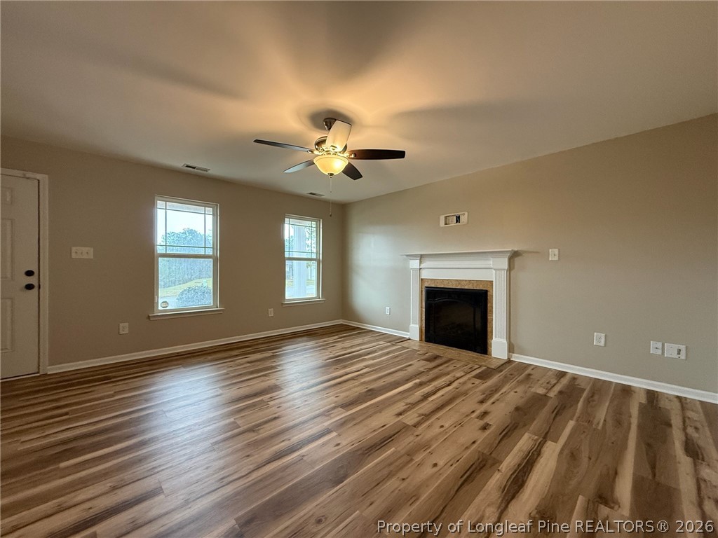 Undisclosed Address Spring Lake, NC 28390 - Photo 8 of 50 a view of an empty room with window and wooden floor