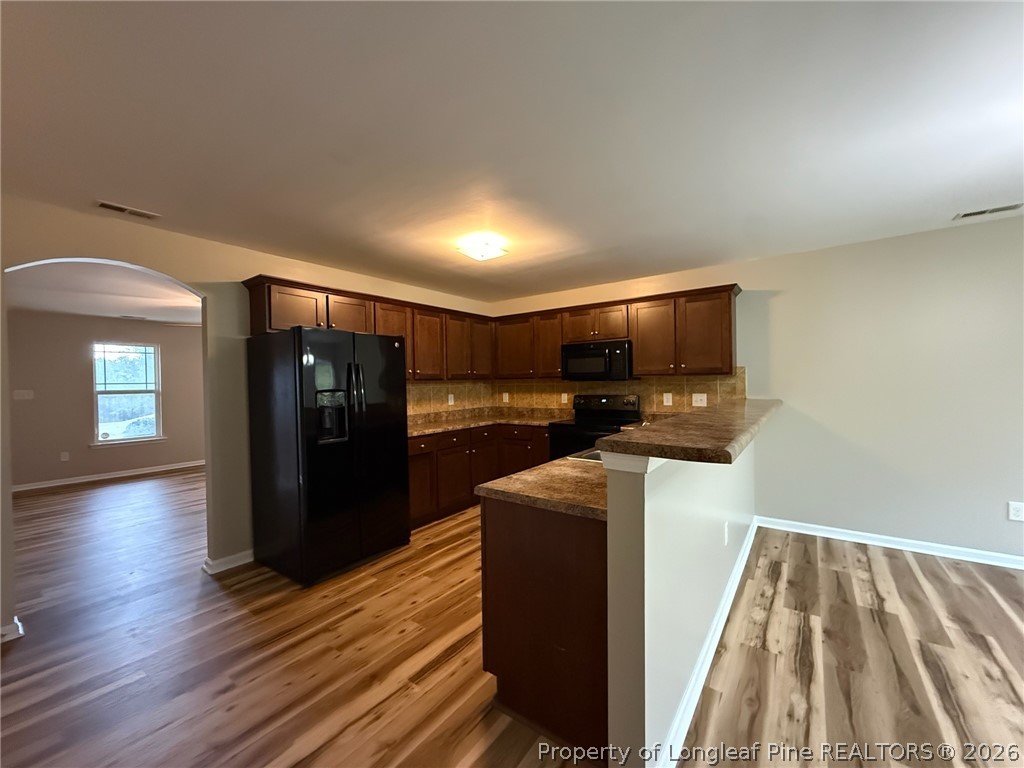Undisclosed Address Spring Lake, NC 28390 - Photo 10 of 50 a kitchen with stainless steel appliances granite countertop a refrigerator and a stove top oven