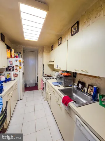 a kitchen with a sink dishwasher and a stove top oven