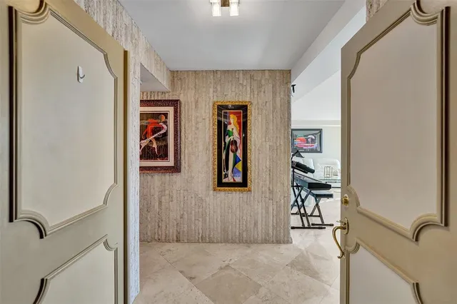 a living room with furniture and a painting on the wall