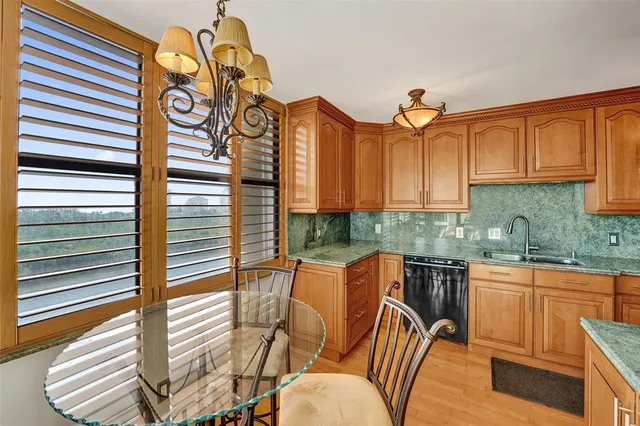 a living room with furniture and floor to ceiling windows