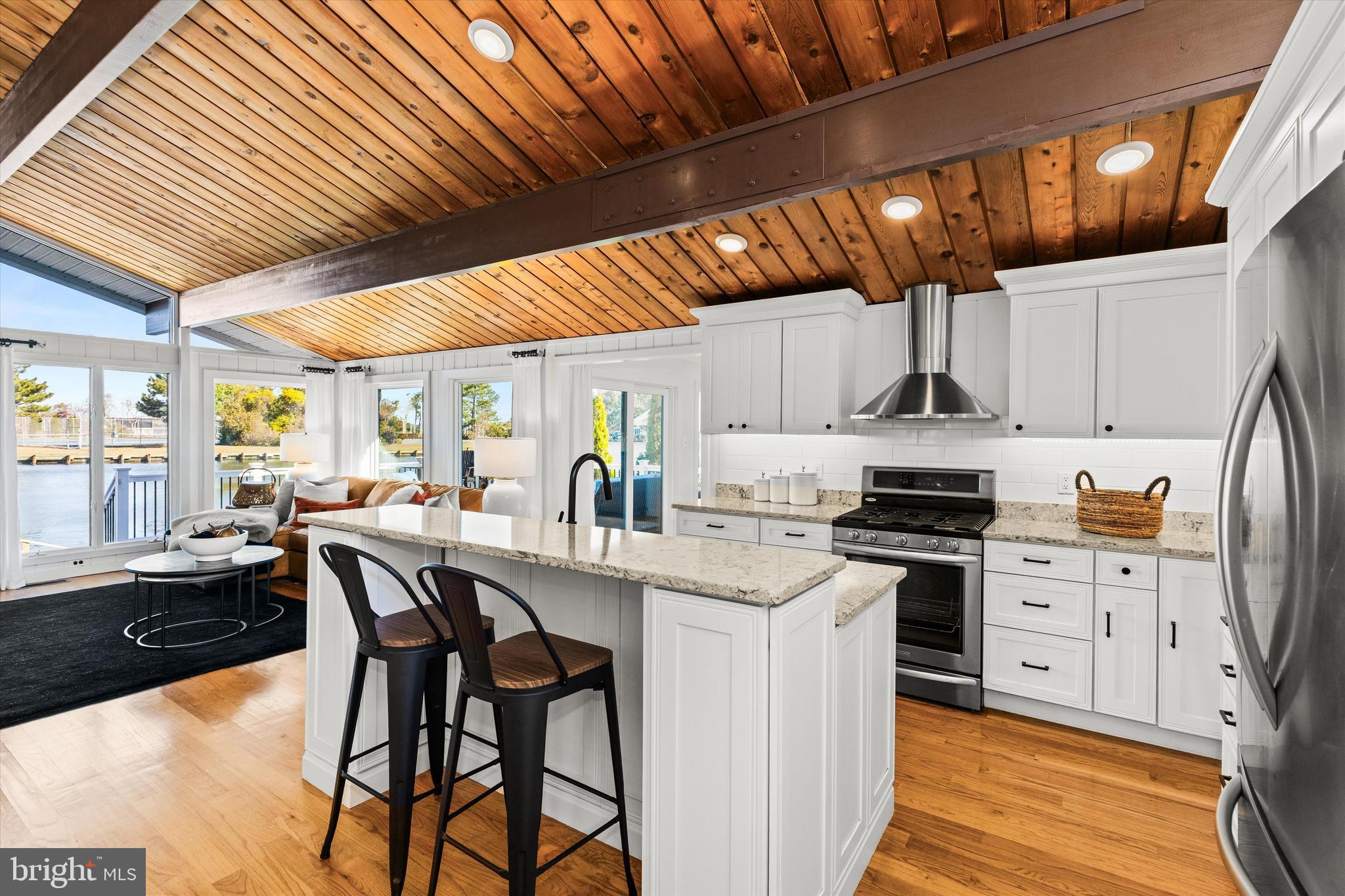 61 Grand Port Road Ocean Pines, MD 21811 - Photo 30 of 68 a kitchen with stainless steel appliances kitchen island granite countertop a table chairs and a refrigerator