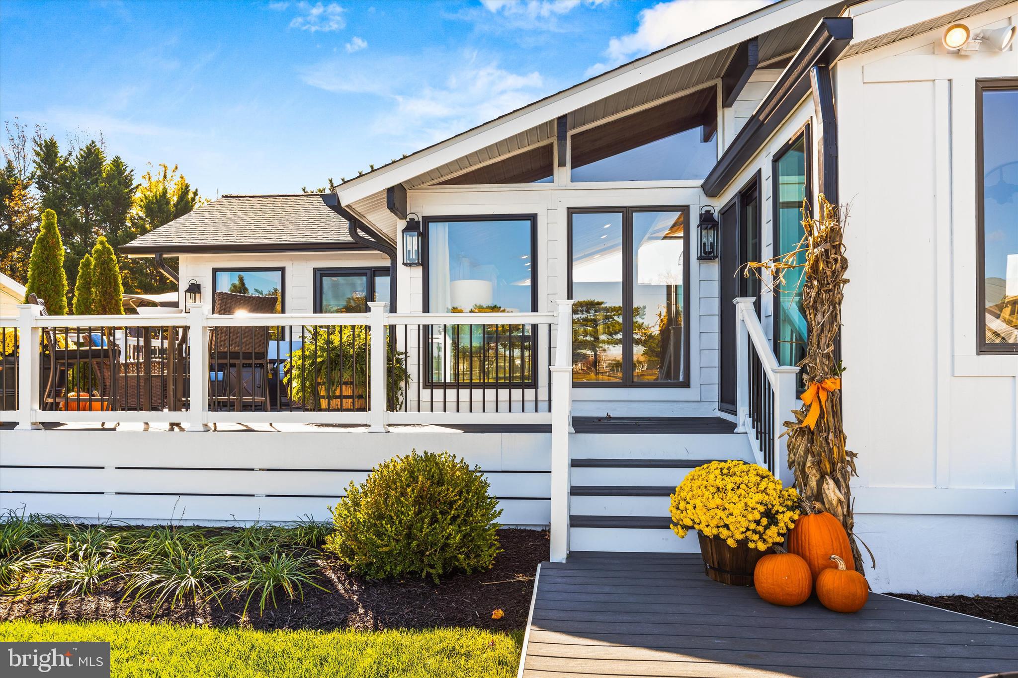 61 Grand Port Road Ocean Pines, MD 21811 - Photo 39 of 68 a front view of a house with a yard outdoor seating and flowers