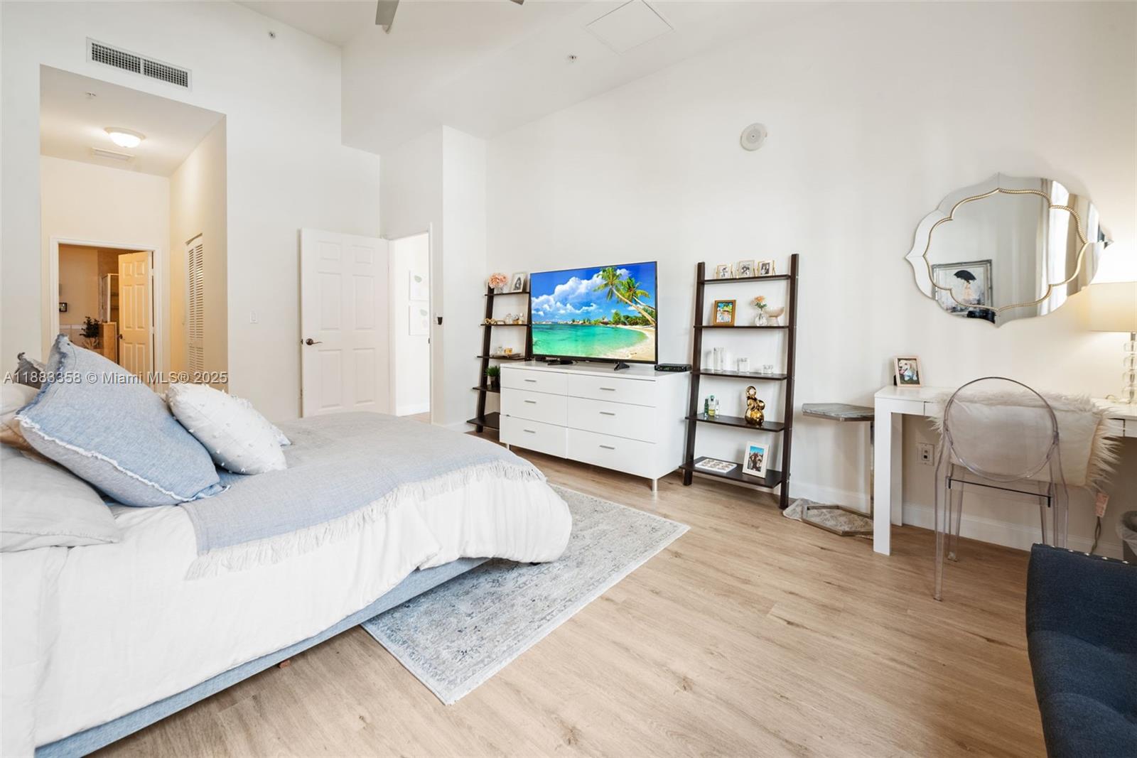 8390 Southwest 72nd Avenue, Unit 314 Miami, FL 33143 - Photo 13 of 35 a bedroom with furniture and a flat screen tv