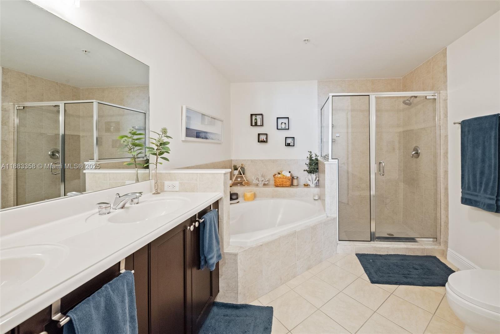 8390 Southwest 72nd Avenue, Unit 314 Miami, FL 33143 - Photo 15 of 35 a bathroom with a tub a sink and a large mirror