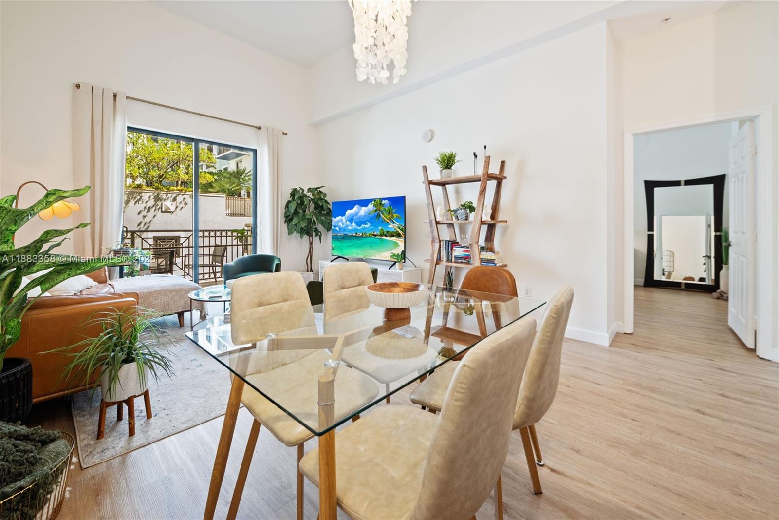 8390 Southwest 72nd Avenue, Unit 314 Miami, FL 33143 - Photo 2 of 35 a dining room with furniture a large window and wooden floor
