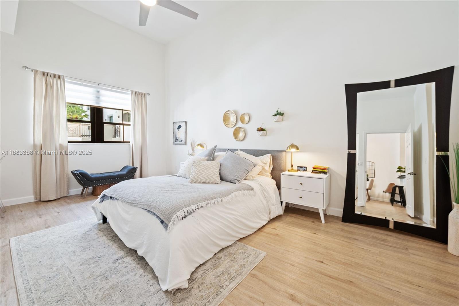8390 Southwest 72nd Avenue, Unit 314 Miami, FL 33143 - Photo 10 of 35 a spacious bedroom with a bed and a large mirror