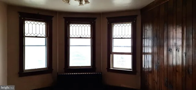 a view of an entryway with wooden floor and windows