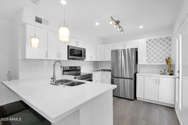 a kitchen with refrigerator cabinets and wooden floor