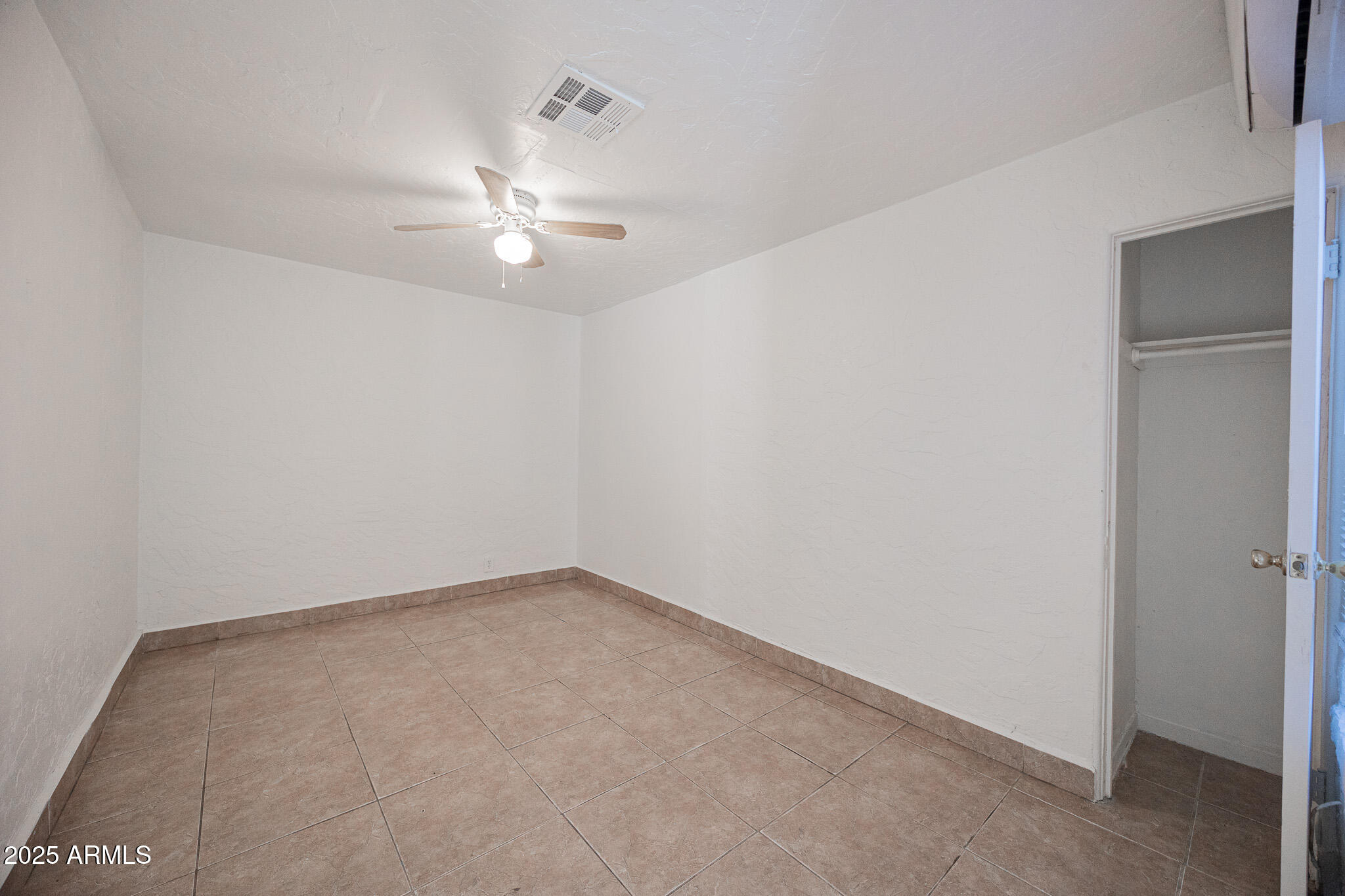 2537 East Willetta Street, Unit 4 Phoenix, AZ 85008 - Photo 12 of 15 an empty room with a fan & a window