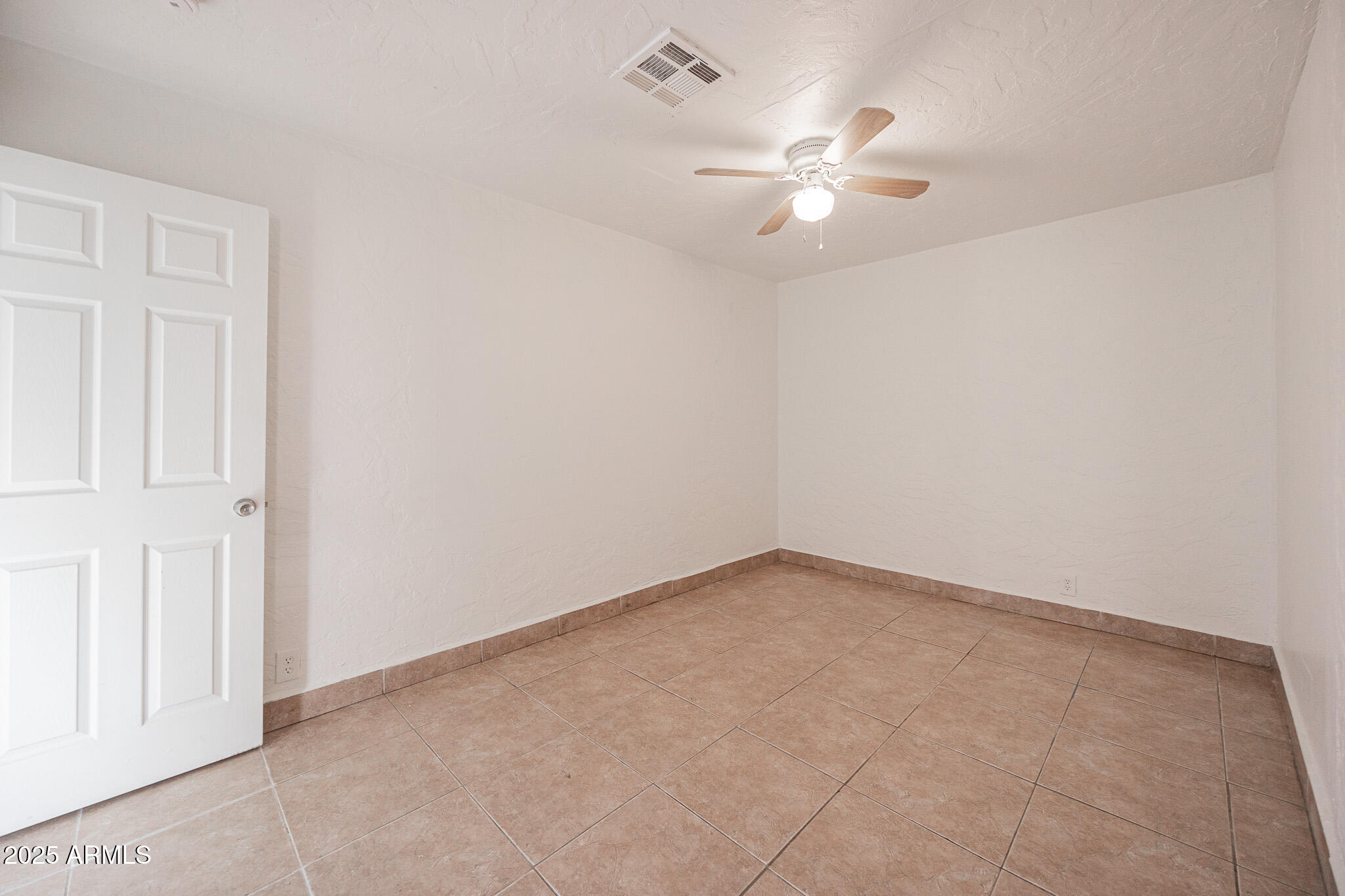 2537 East Willetta Street, Unit 4 Phoenix, AZ 85008 - Photo 15 of 15 an empty room with a chandelier fan and closet area