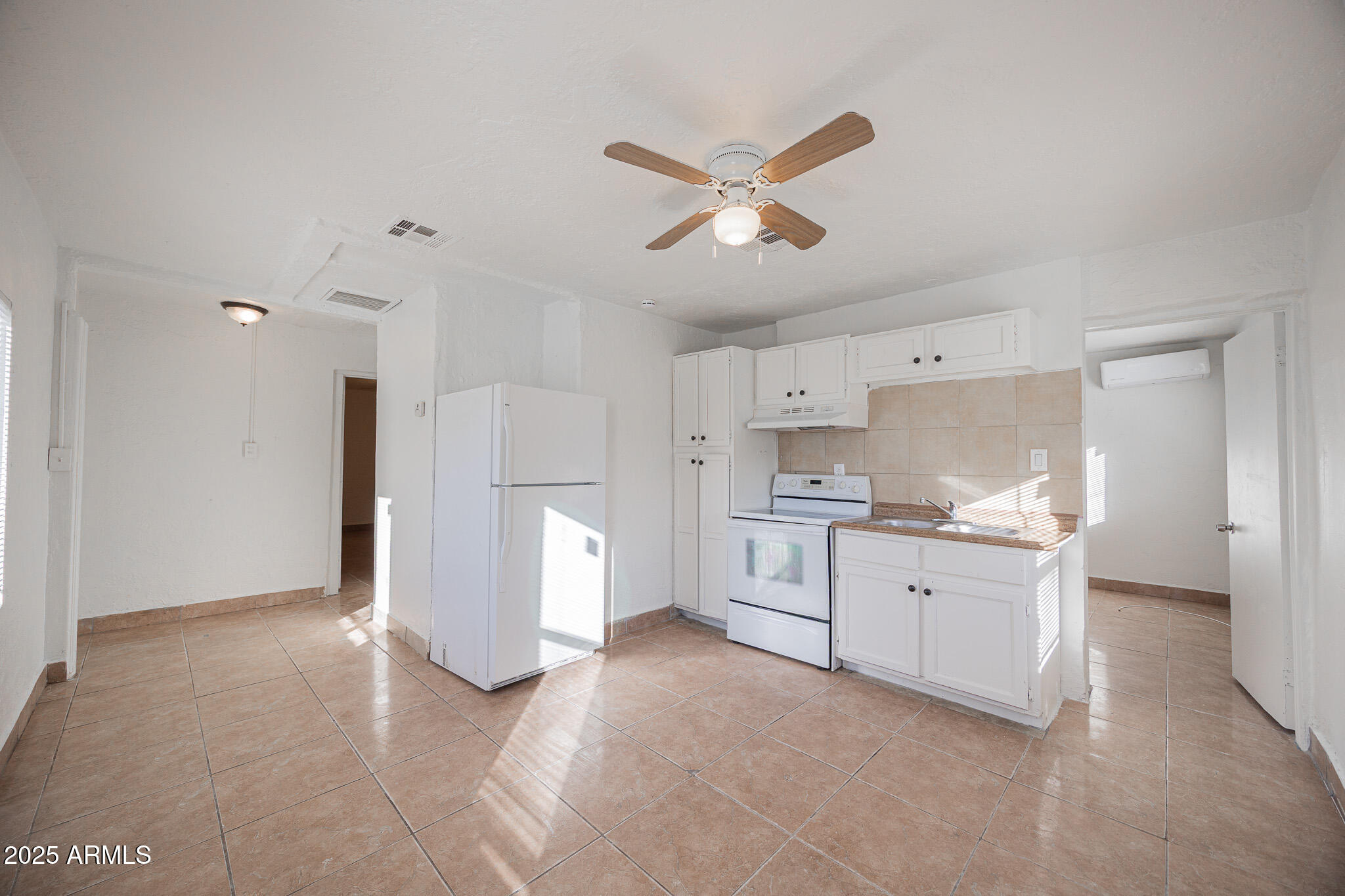 2537 East Willetta Street, Unit 4 Phoenix, AZ 85008 - Photo 5 of 15 a large white kitchen with a stove a sink dishwasher and a refrigerator with white cabinets