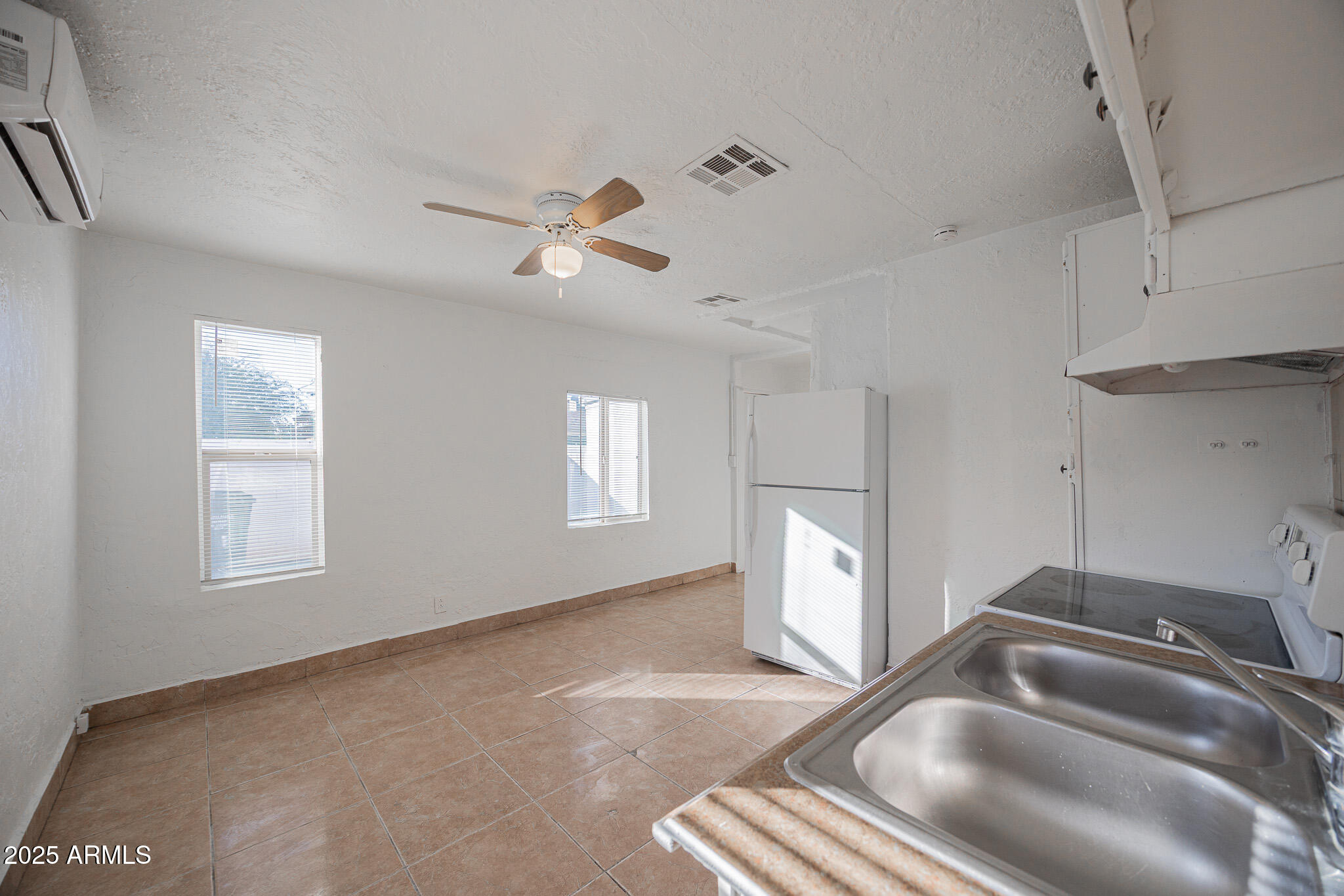 2537 East Willetta Street, Unit 4 Phoenix, AZ 85008 - Photo 6 of 15 a kitchen with a refrigerator a sink and dishwasher