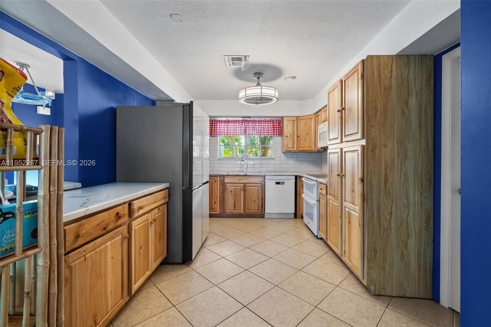 5741 Southwest 14th Street Plantation, FL 33317 - Photo 11 of 29 a kitchen with stainless steel appliances a refrigerator and a stove