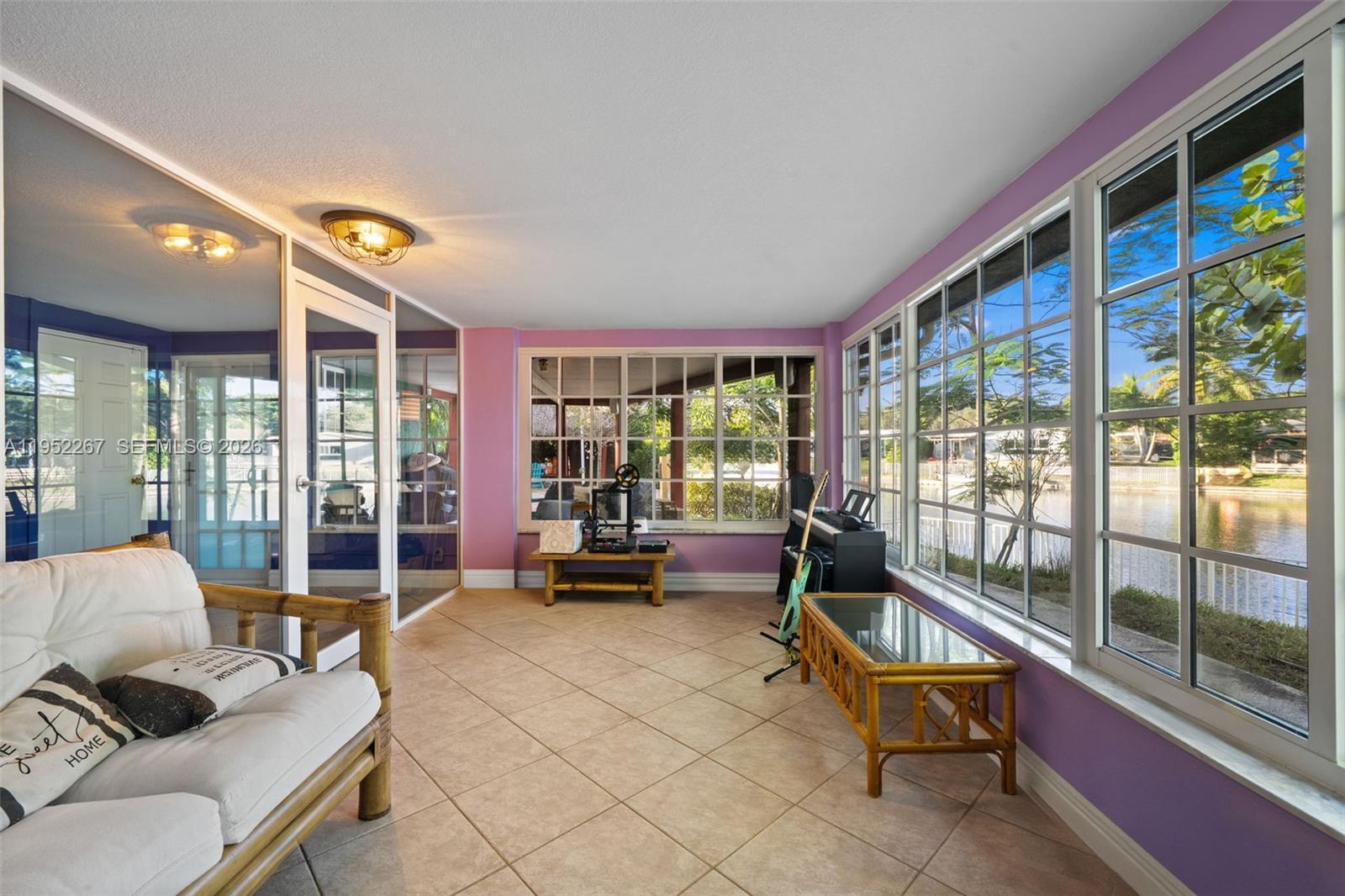 5741 Southwest 14th Street Plantation, FL 33317 - Photo 16 of 29 a living room with furniture and a floor to ceiling window