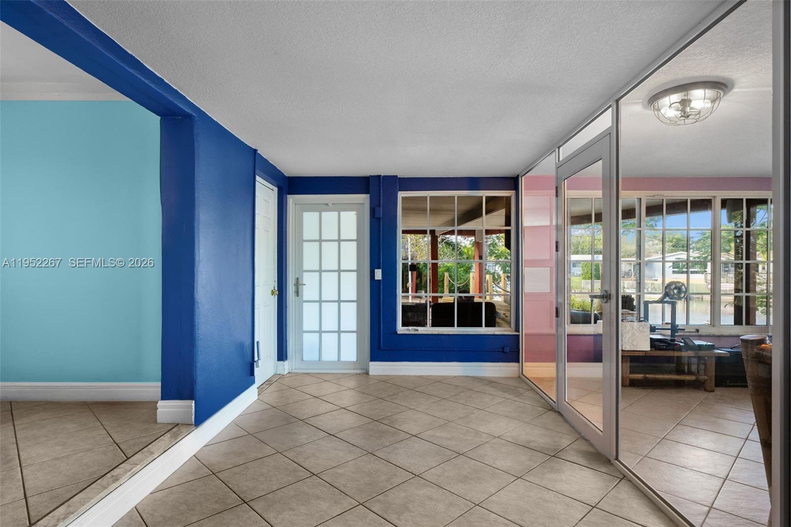 5741 Southwest 14th Street Plantation, FL 33317 - Photo 17 of 29 a living room with furniture and large windows
