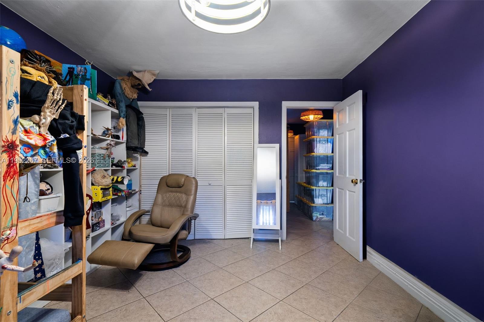5741 Southwest 14th Street Plantation, FL 33317 - Photo 27 of 29 a view of walk in closet with clothes and shoes