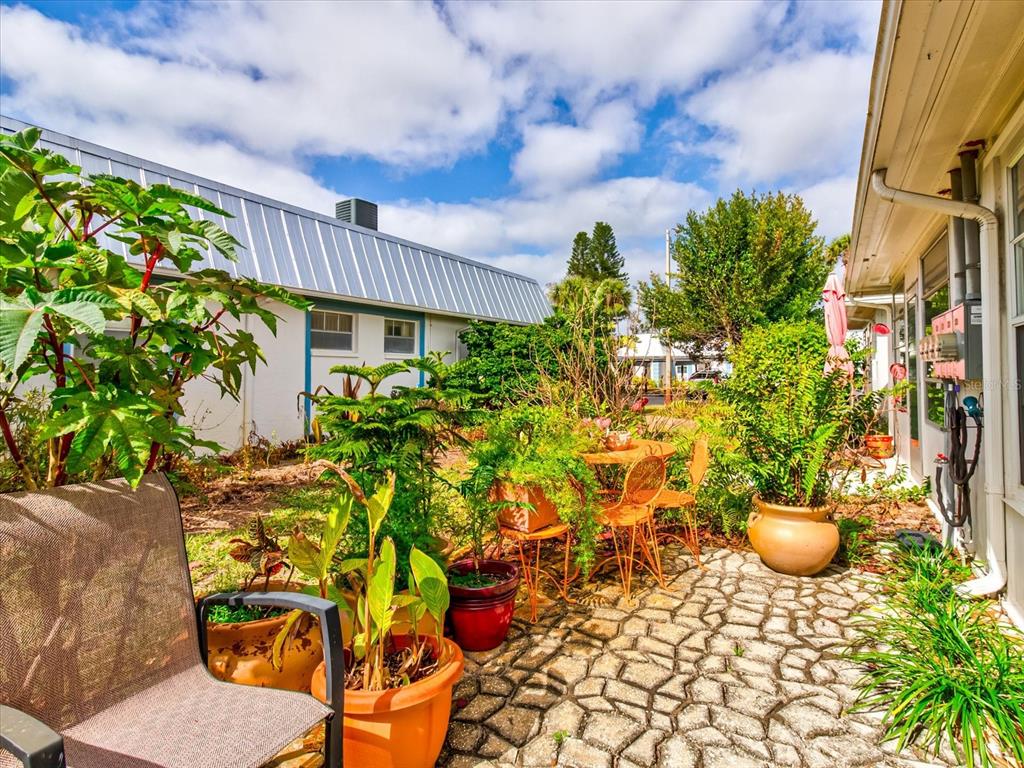 4231 Tamargo Drive, Unit 3 New Port Richey, FL 34652 - Photo 33 of 47 a view of a chairs and table in a patio