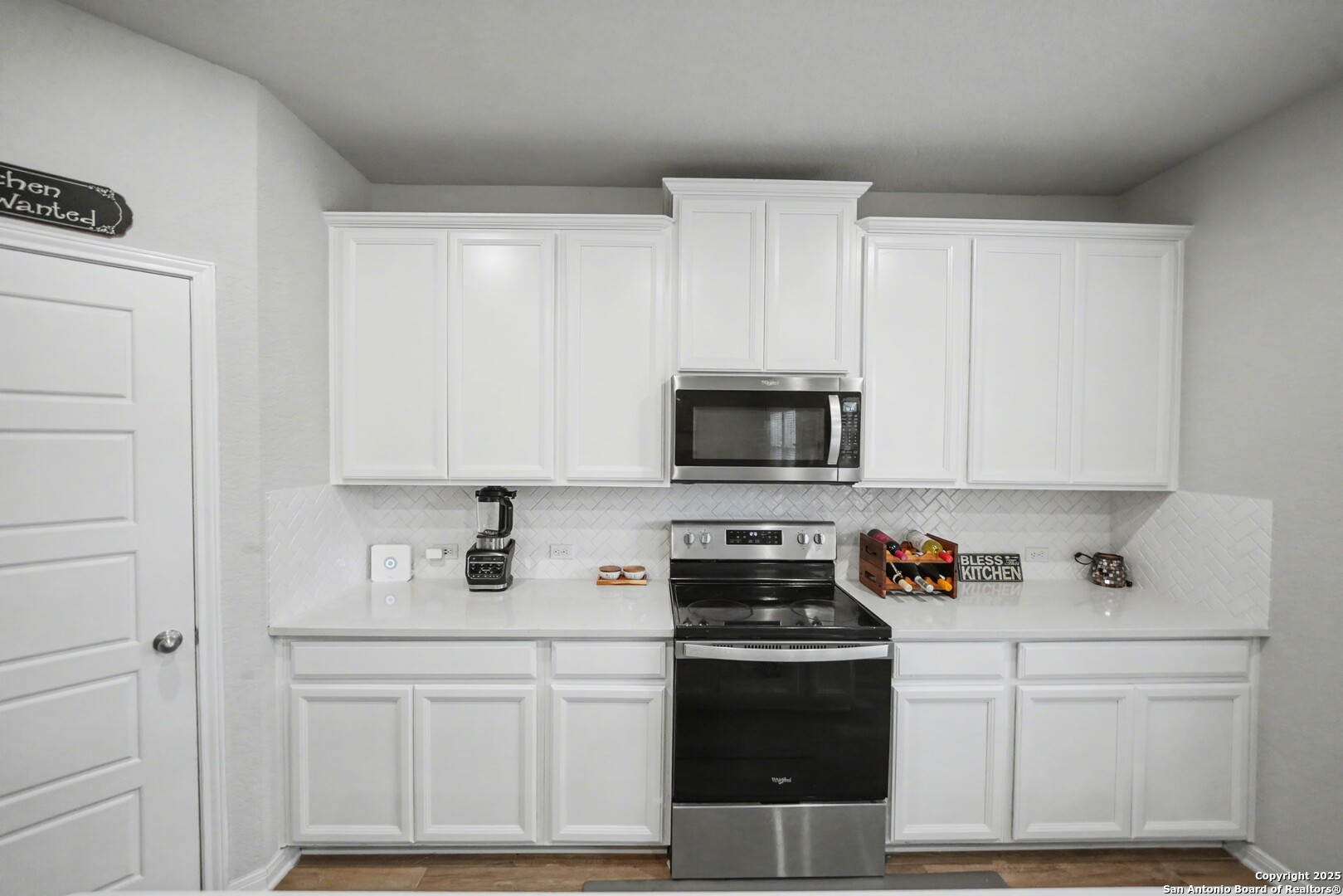 3083 Mondavi Crest Schertz, TX 78154 - Photo 17 of 47 a kitchen with white cabinets and stainless steel appliances