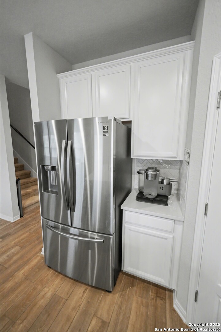 3083 Mondavi Crest Schertz, TX 78154 - Photo 18 of 47 a kitchen with stainless steel appliances a refrigerator and wooden floor