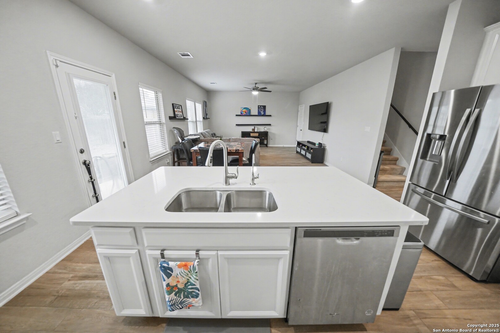3083 Mondavi Crest Schertz, TX 78154 - Photo 19 of 47 a kitchen with a sink a refrigerator and chairs
