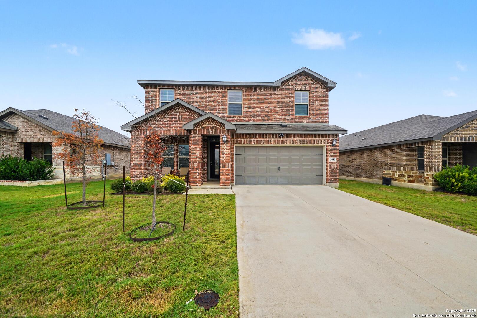 3083 Mondavi Crest Schertz, TX 78154 - Photo 2 of 47 a front view of a house with a yard and garage