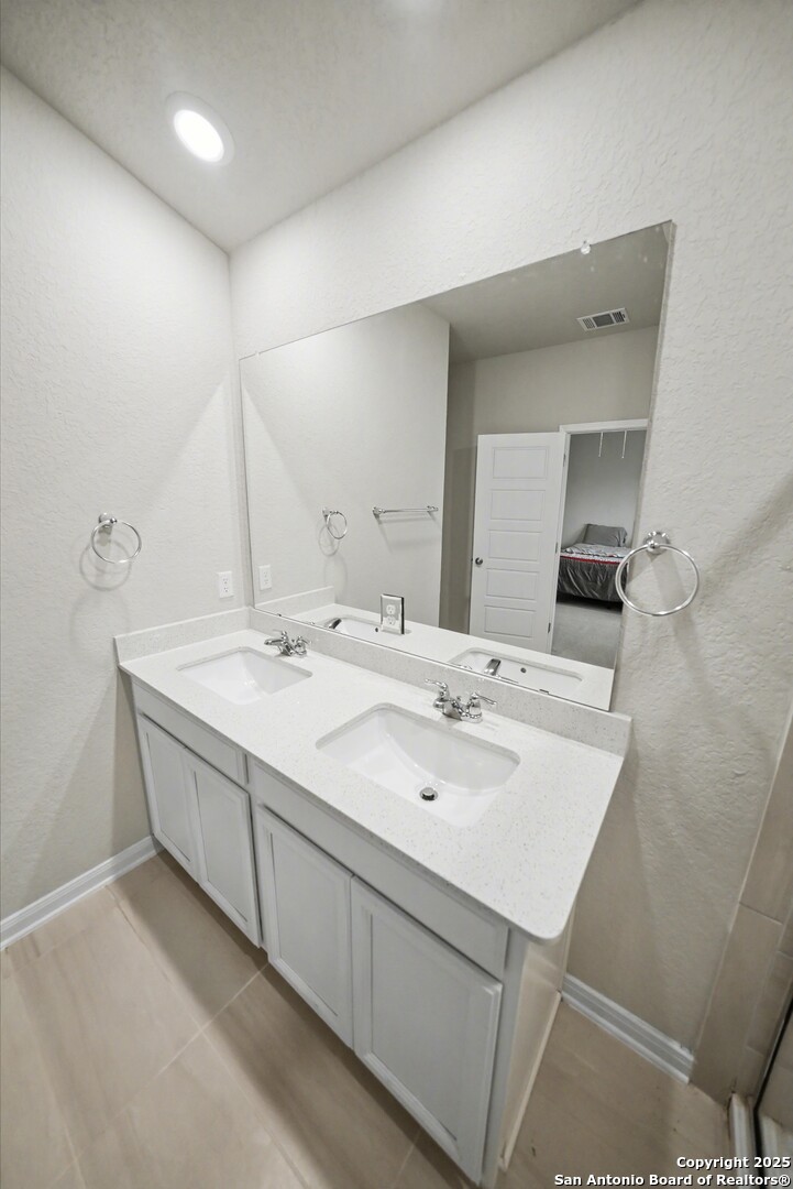 3083 Mondavi Crest Schertz, TX 78154 - Photo 27 of 47 a bathroom with a sink and a mirror