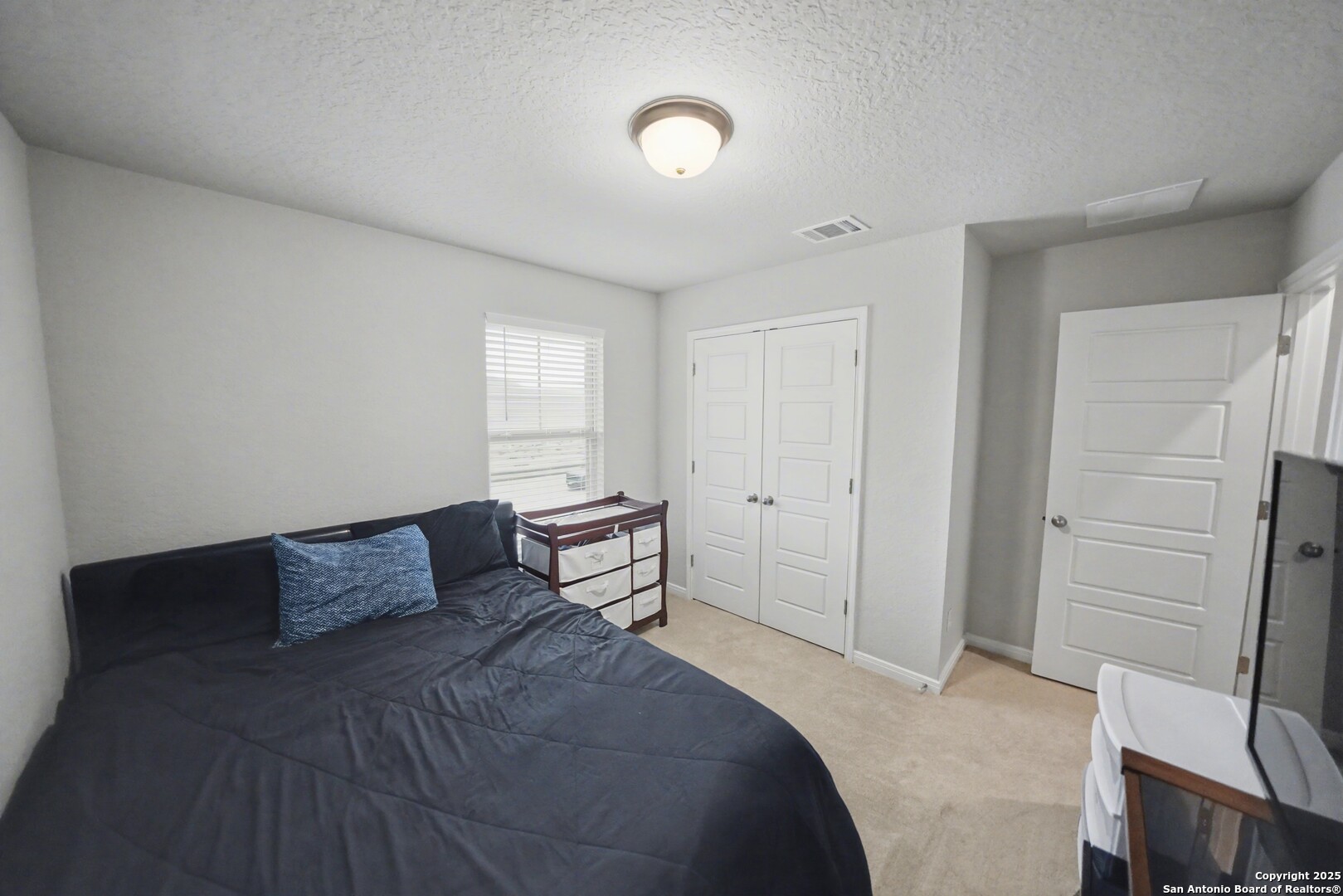 3083 Mondavi Crest Schertz, TX 78154 - Photo 40 of 47 a bedroom with a bed and a cabinets