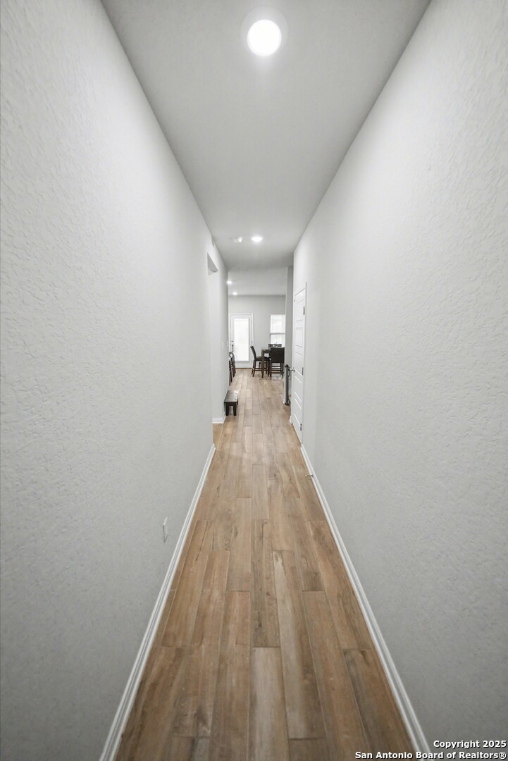 3083 Mondavi Crest Schertz, TX 78154 - Photo 7 of 47 a view of a hallway with wooden floor