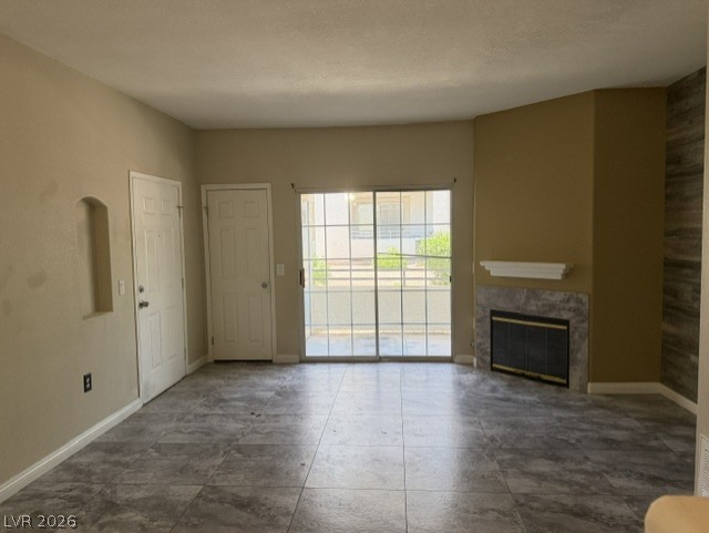 3318 North Decatur Boulevard, Unit 1163 Las Vegas, NV 89130 - Photo 29 of 35 Floor-to-ceiling glass doors provide abundant natural light, highlighting the sleek tile flooring and a cozy fireplace.