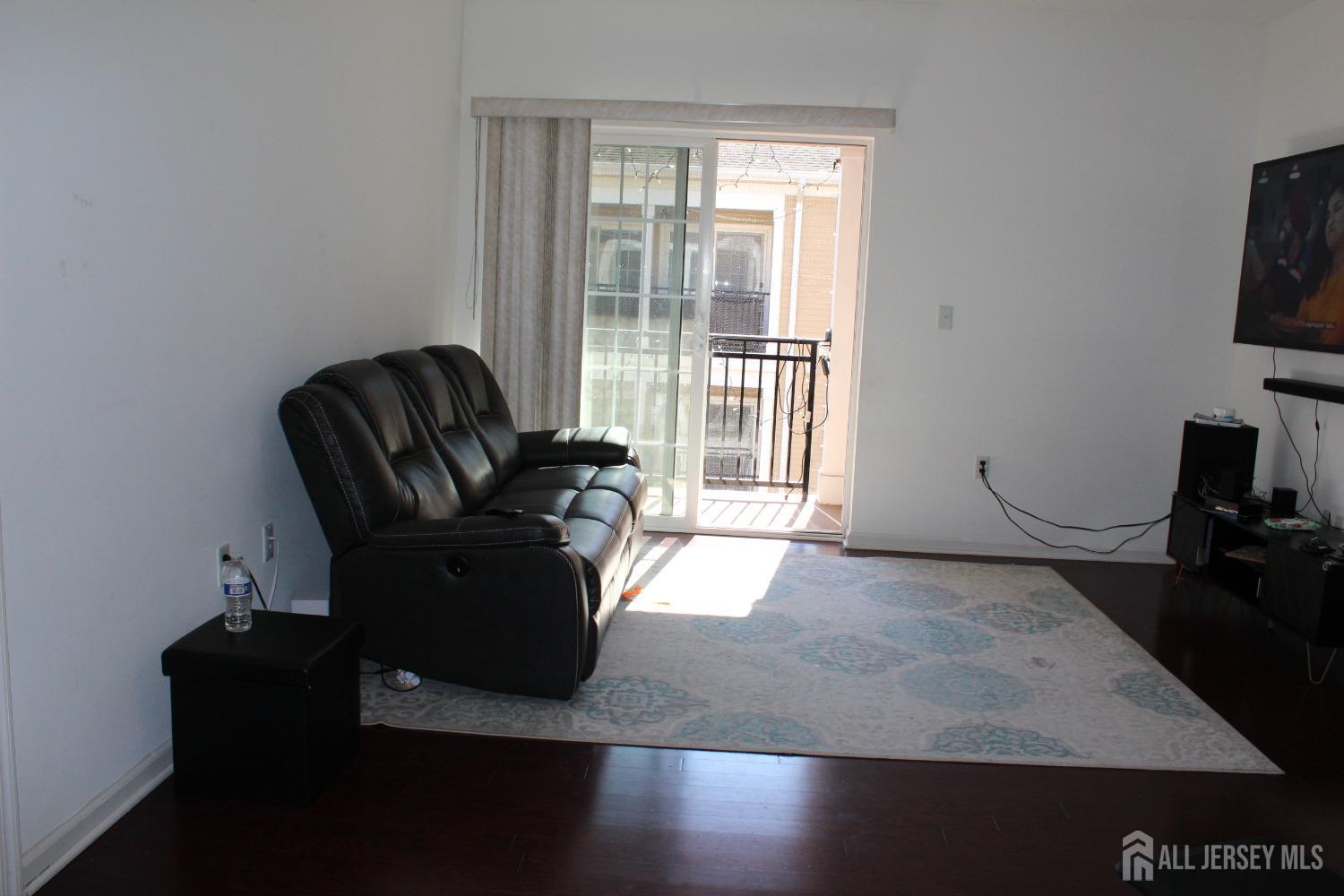 446 Micali Way South Plainfield, NJ 07080 - Photo 12 of 26 a living room with furniture and a flat screen tv