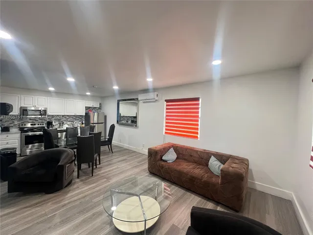 a bedroom with two beds and a large window