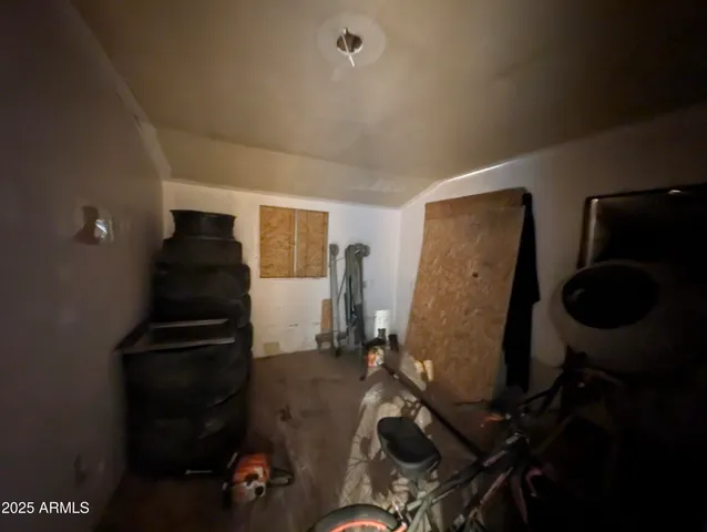 a view of a hallway with kitchen and chandelier
