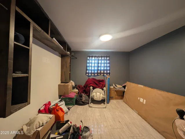 a bedroom with furniture and a window