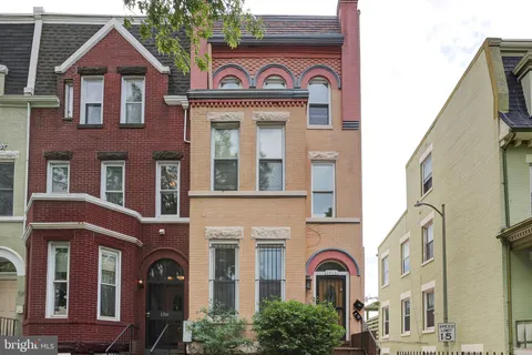 a view of a brick house with large windows