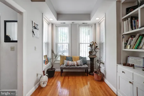 a living room with furniture and a book shelf