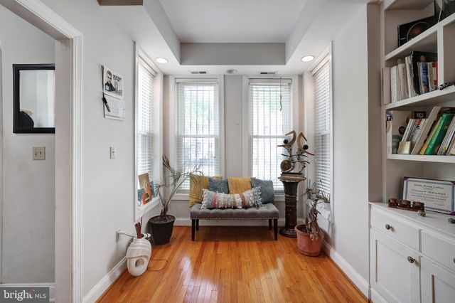 a living room with furniture and a book shelf