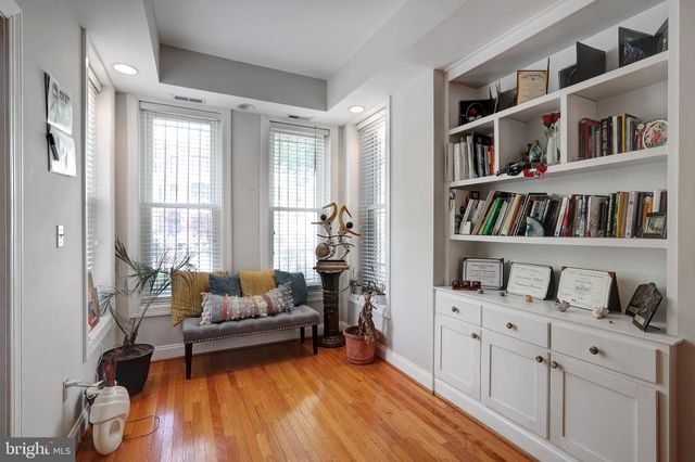 a living room with furniture and a book shelf