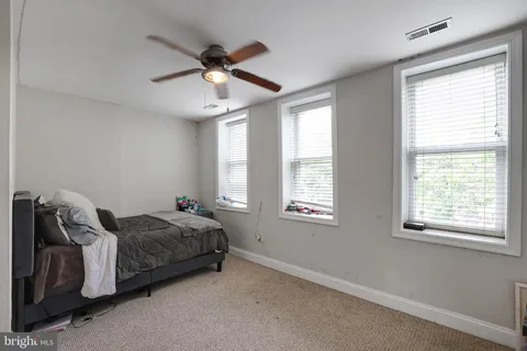 a bed room with a bed and a window