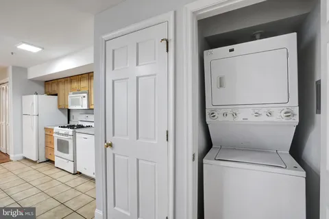 a view of washer and dryer with kitchen in the background