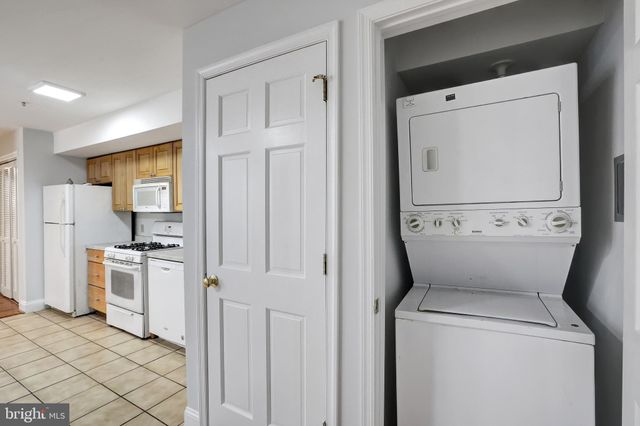 a view of washer and dryer with kitchen in the background