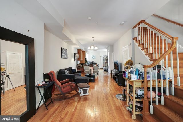 a living room with lots of wooden furniture and a wooden floor