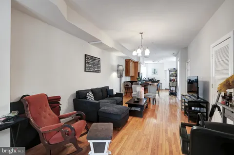 a living room with furniture a fireplace and a chandelier