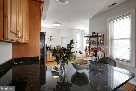 a very nice looking dining room with a chair and a potted plant