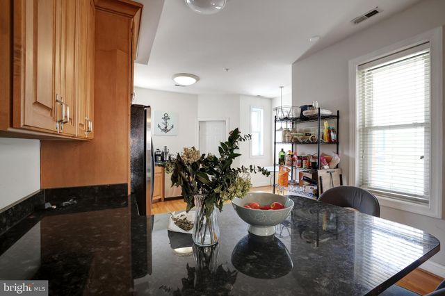 a very nice looking dining room with a chair and a potted plant